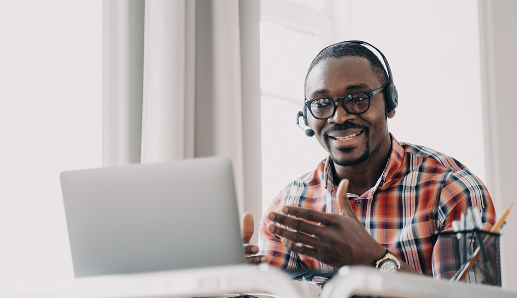 Un homme, téléconseiller, devant son écran d'ordinateur